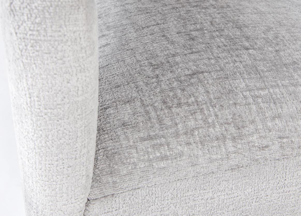 Close-up of gray textured upholstery on a chair.