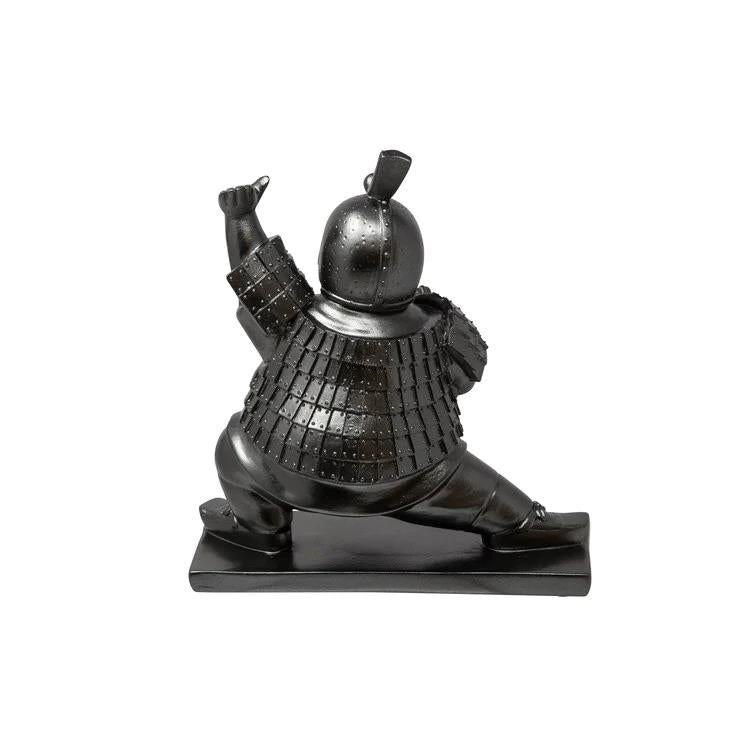 Bronze sculpture of a warrior in traditional armor, dynamic pose.