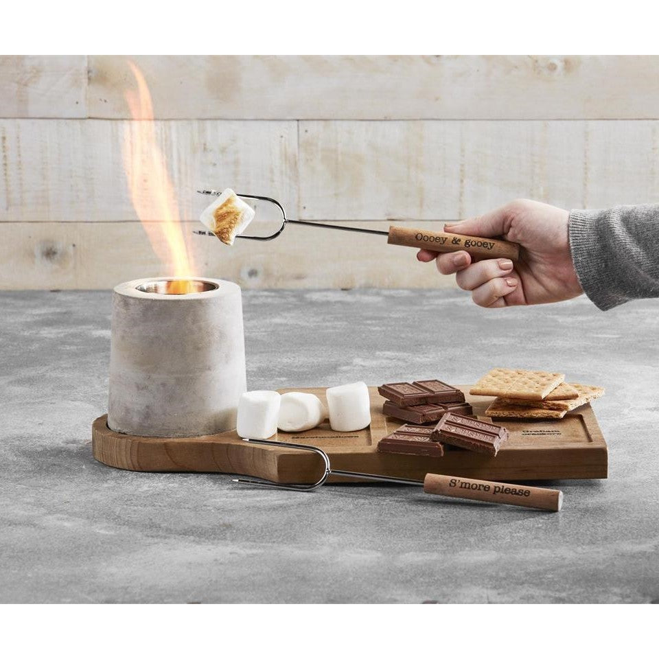 Roasting marshmallows over a tabletop fire for s'mores.
