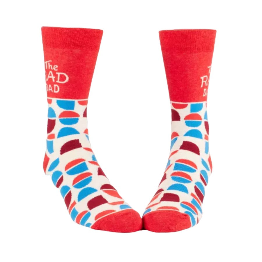 Red socks with colorful geometric patterns and playful text design.