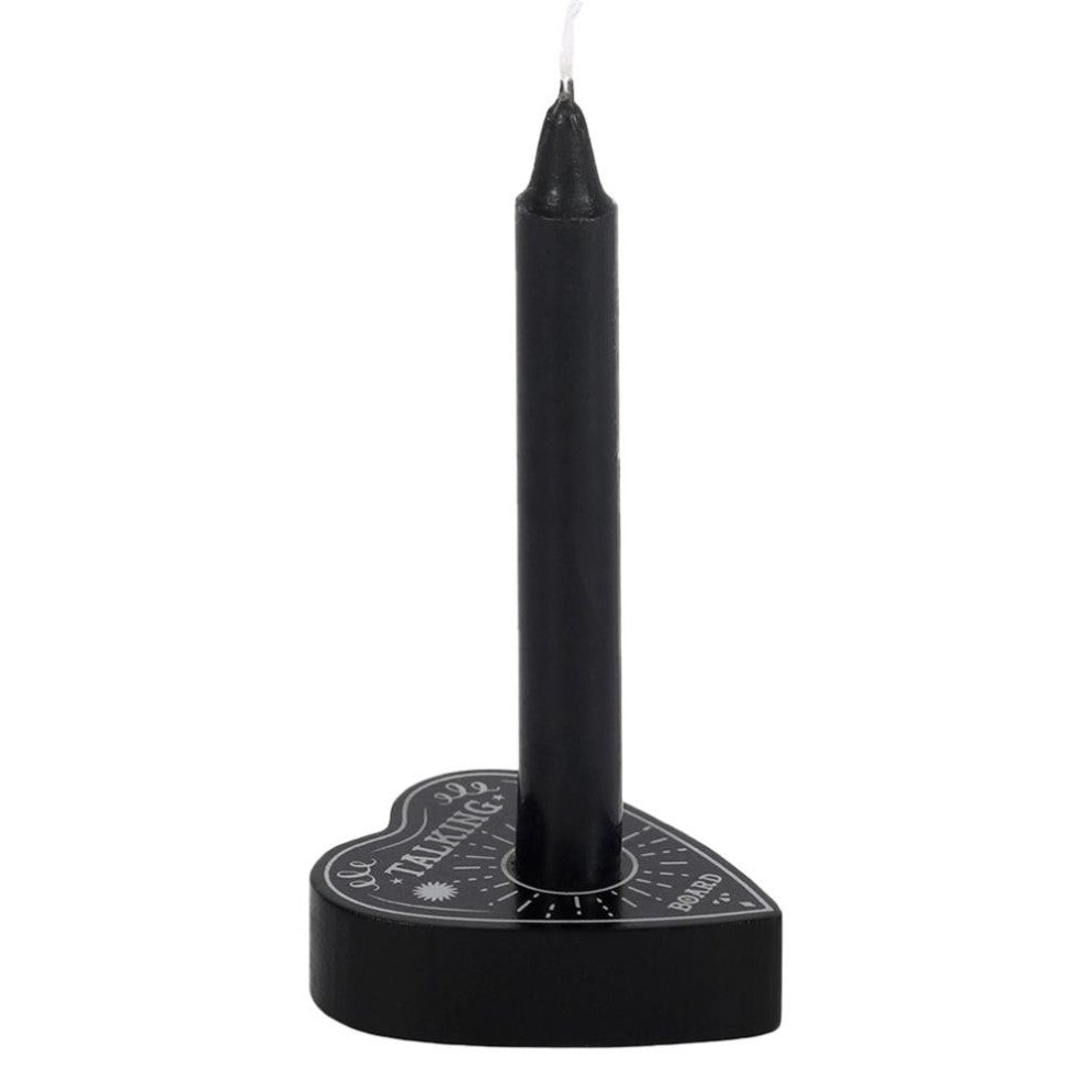 Black candle in a heart-shaped holder with decorative text.