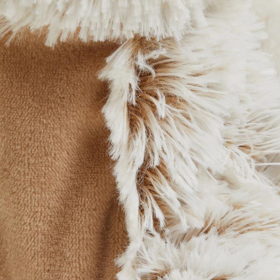 Beige and white fluffy blanket close-up.