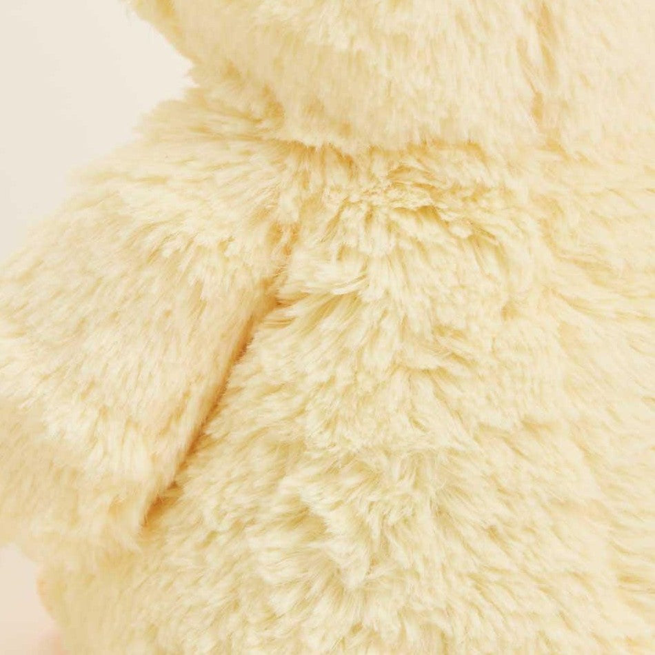 Close-up of fluffy beige faux fur texture.