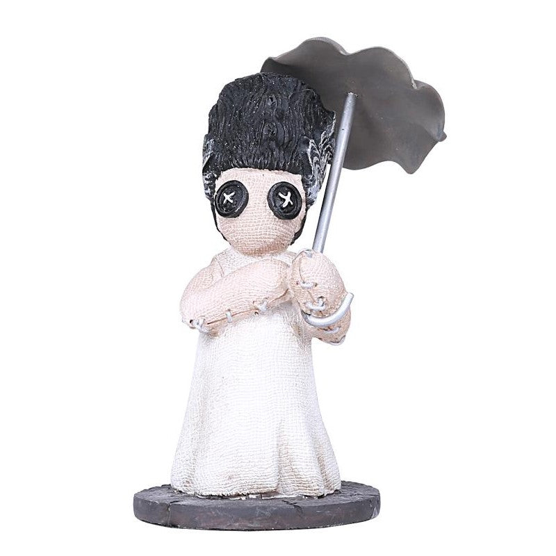Cute doll with button eyes holding a gray umbrella.