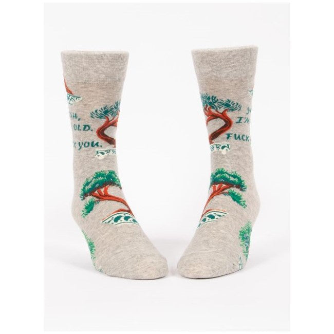 Gray socks featuring trees and a humorous, bold message.