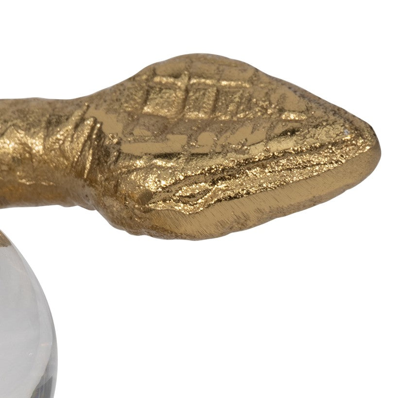 Golden paddle detail with textured pattern.