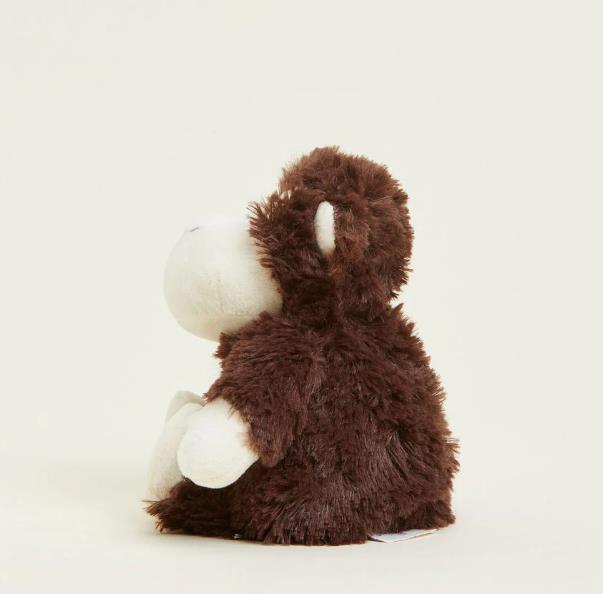 Plush brown monkey toy sitting against a plain background.