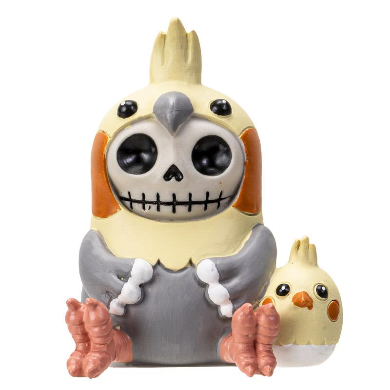Bird figurine with skull face, orange cheeks, and a smaller bird companion.
