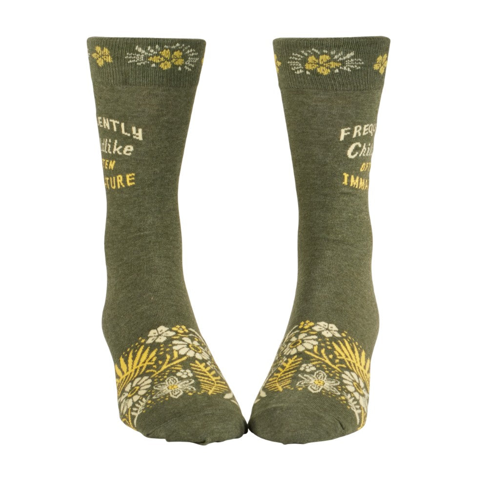 Green socks with floral patterns and a humorous quote.