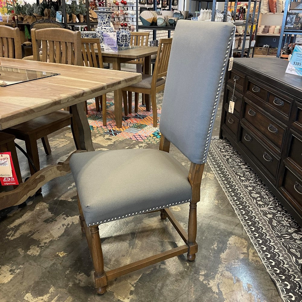 Upholstered chair with wood frame in a furniture store.