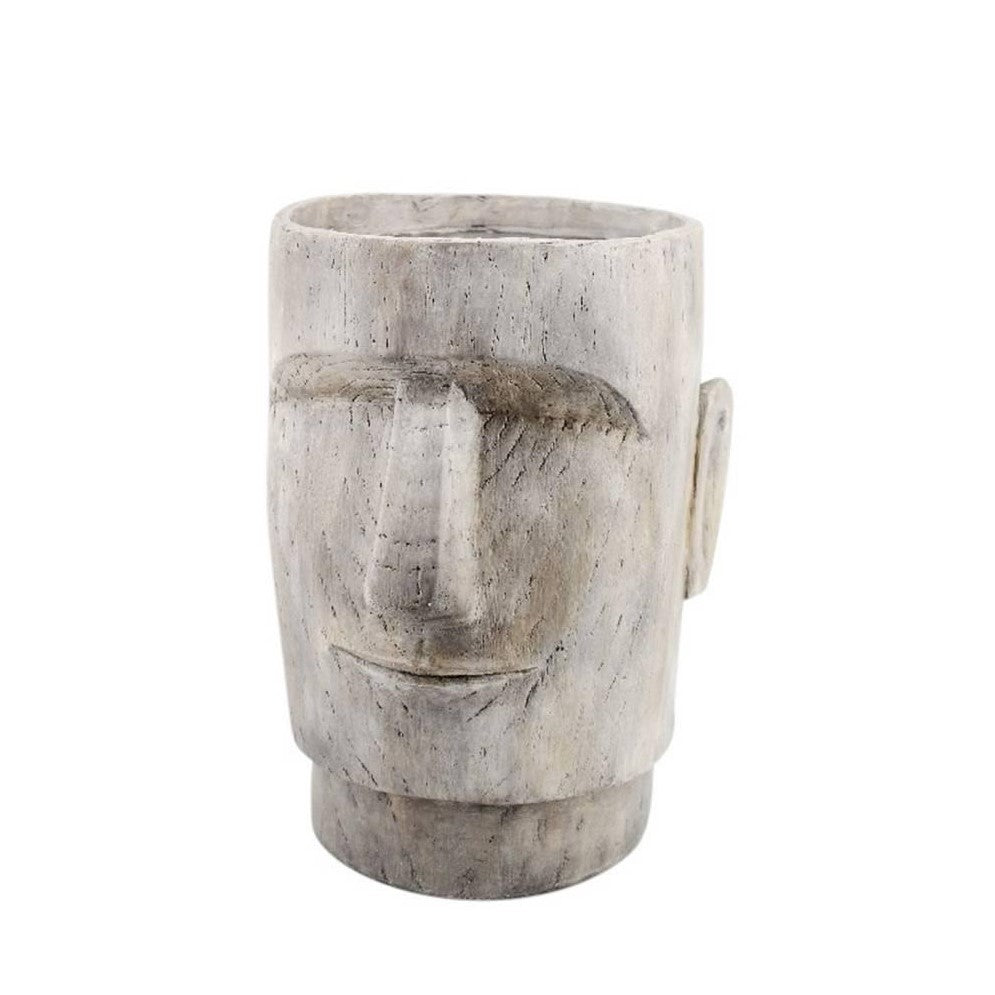 Wooden vase with a carved face design.