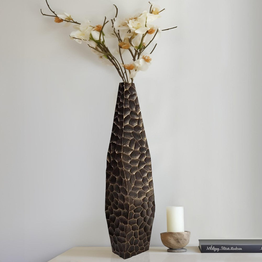 Tall textured vase with white flowers.