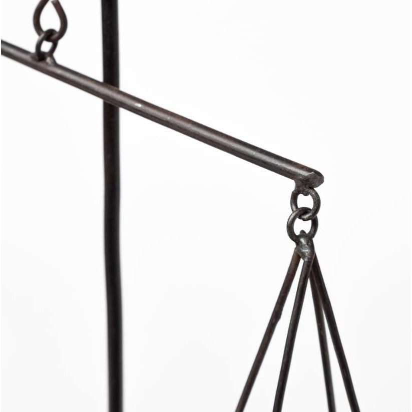 Close-up of a vintage metal balance scale.