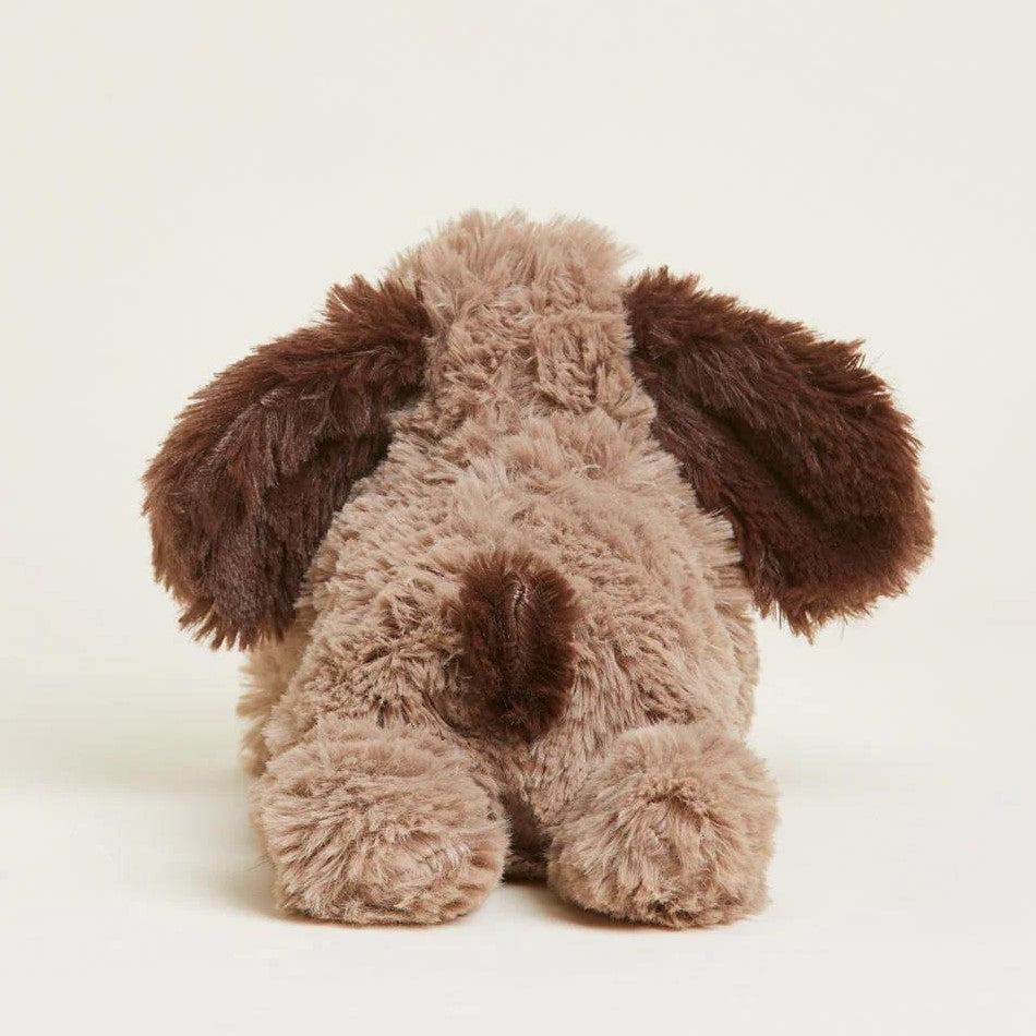Fluffy toy dog seen from behind, with big ears and a soft tail.