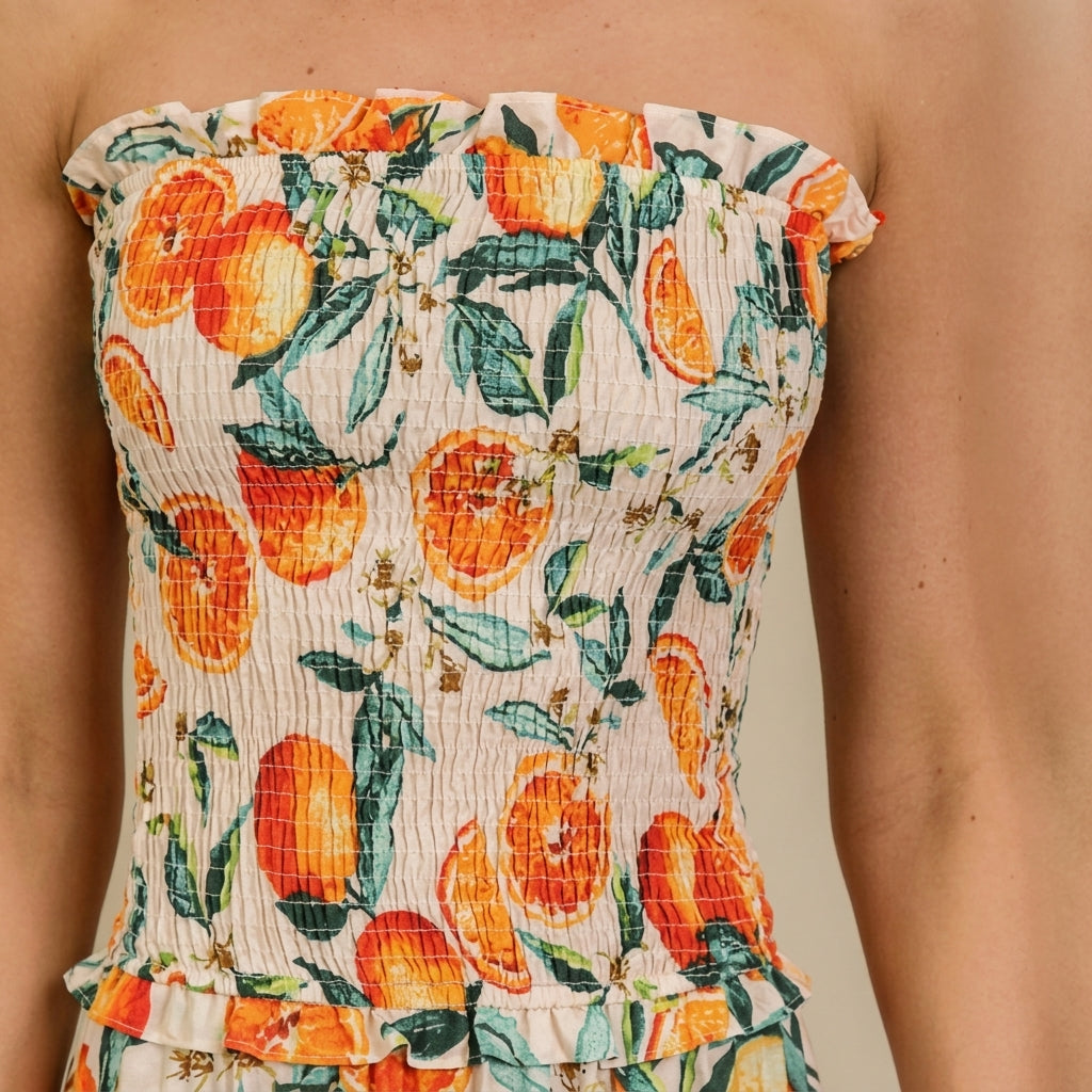 Strapless dress with vibrant citrus and leaf pattern.