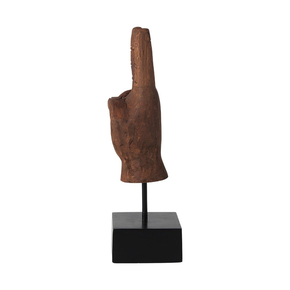 Carved wooden hand sculpture on a black base.