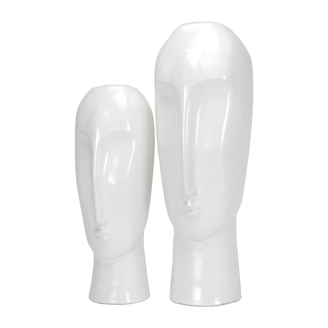 Two white ceramic faces, minimalist style, side by side.