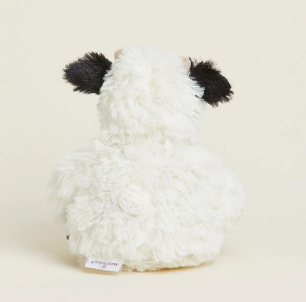 Fluffy white plush toy with black ears seen from behind.