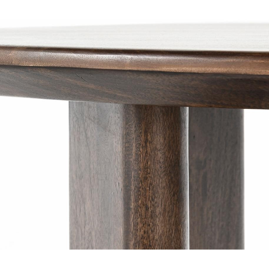 Close-up of a wooden table edge with cylindrical legs.