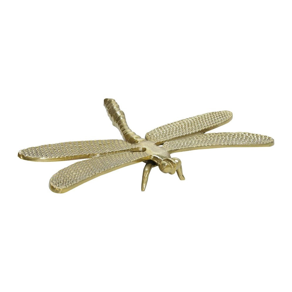Golden dragonfly sculpture with detailed wings.