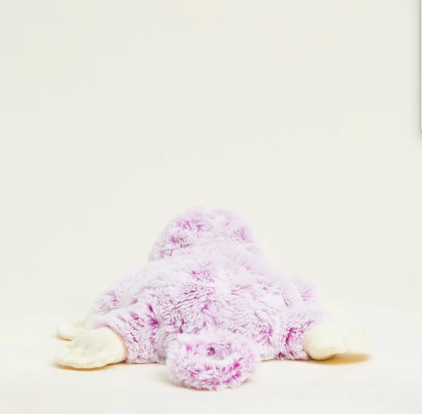 Fluffy pink stuffed animal lying face down.