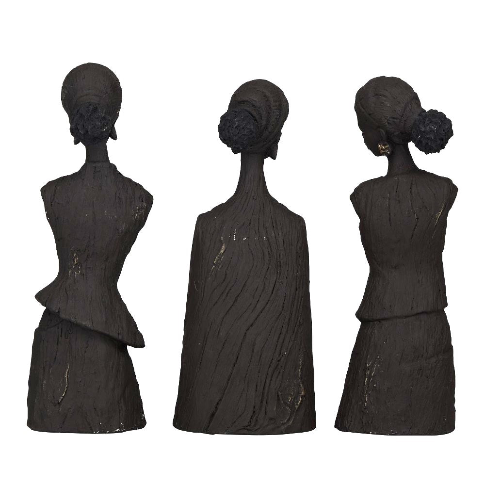 Three abstract, dark sculptures of figures with bun hairstyles.