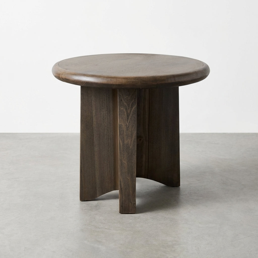Dark wooden round side table on a gray floor.