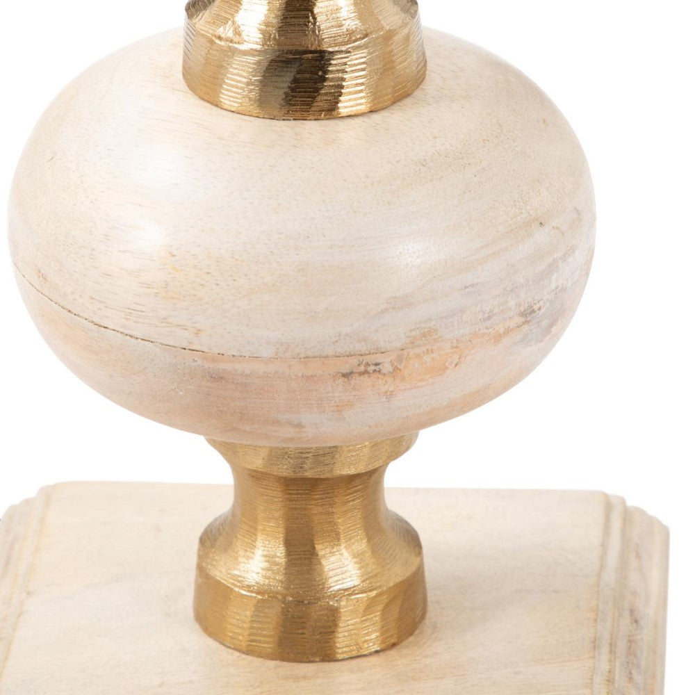 Wooden ornament with gold accents on a square base.