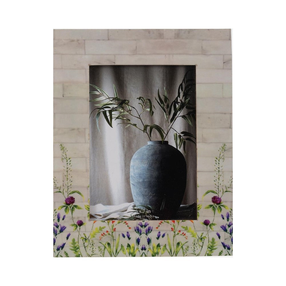 Floral frame with vase and greenery centerpiece.