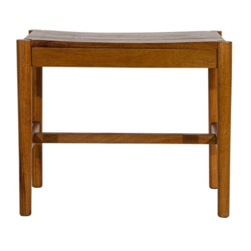 Wooden bench with a minimalist design and curved seat.