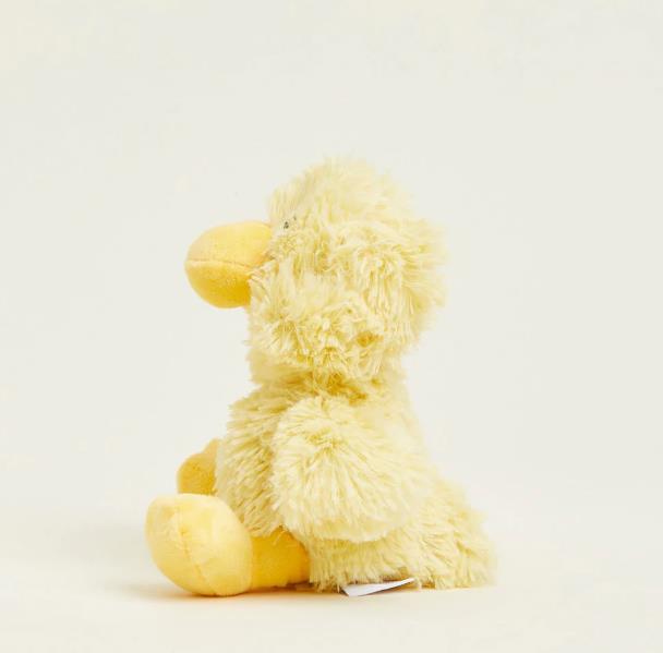 Side view of a fluffy yellow duck plush toy.