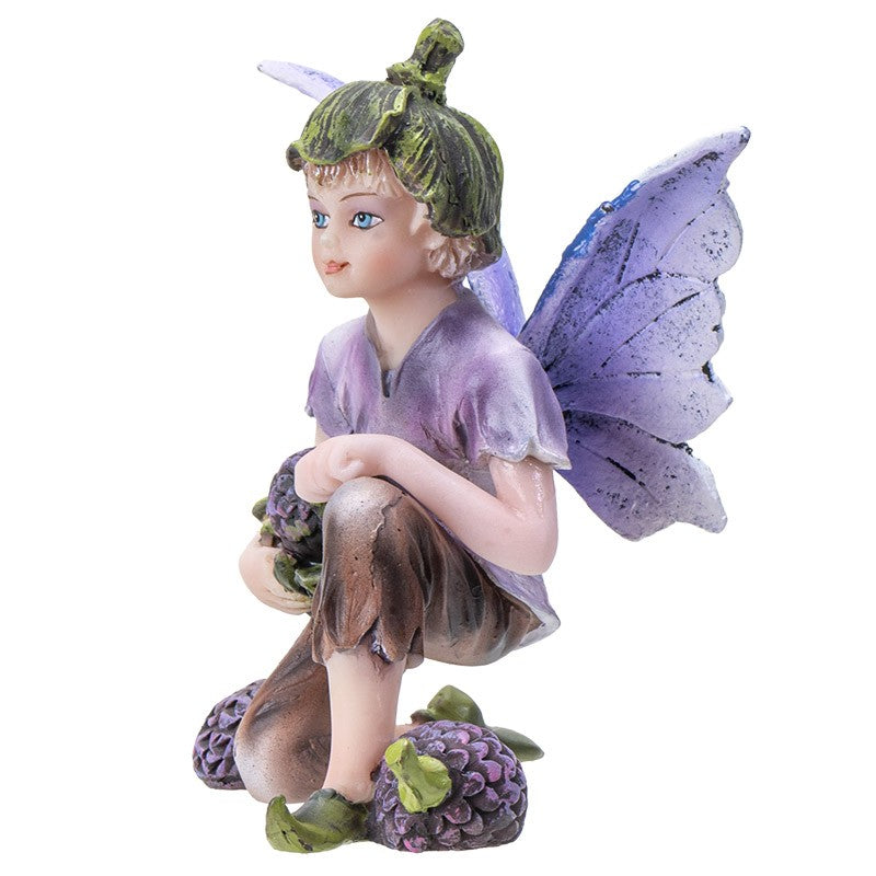 Fairy figurine with purple wings and a green hat, crouching gracefully.