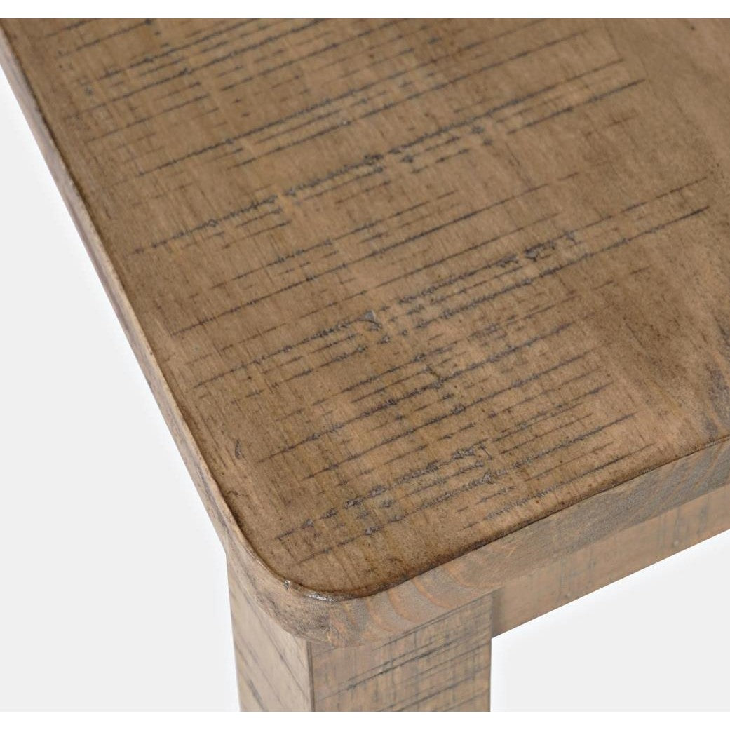 Close-up of rustic wooden table corner with visible grain.