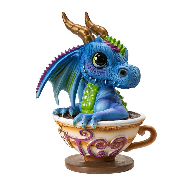 Cute blue dragon with golden horns in a teacup.