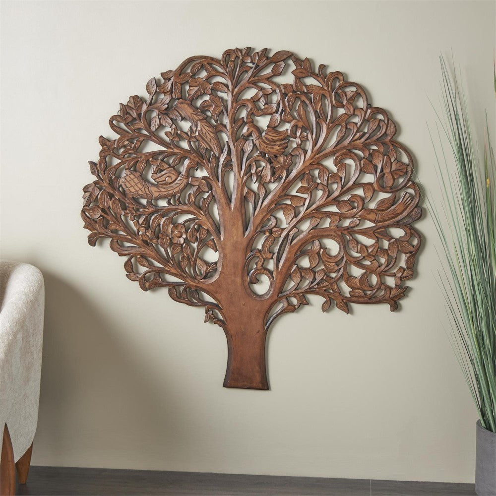 Intricate wooden tree wall art with leaves and bird motifs.