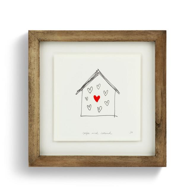 Framed sketch of a house with hearts, one red, titled "Safe and Sound."