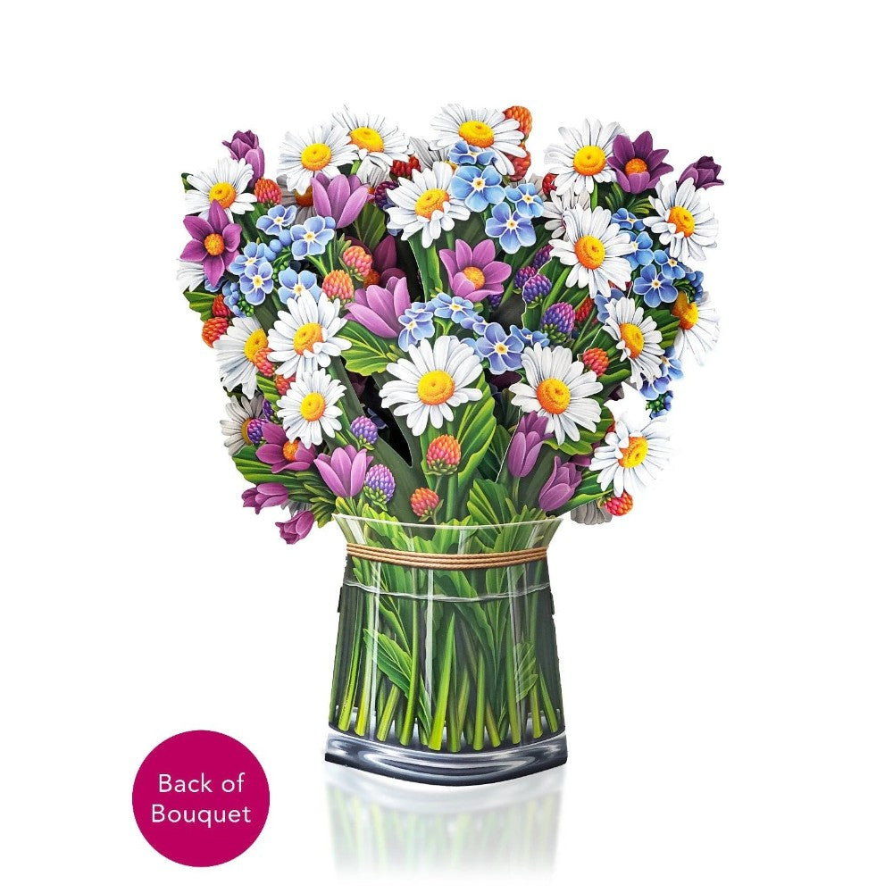 Colorful clay bouquet in a glass vase with daisies and various flowers.