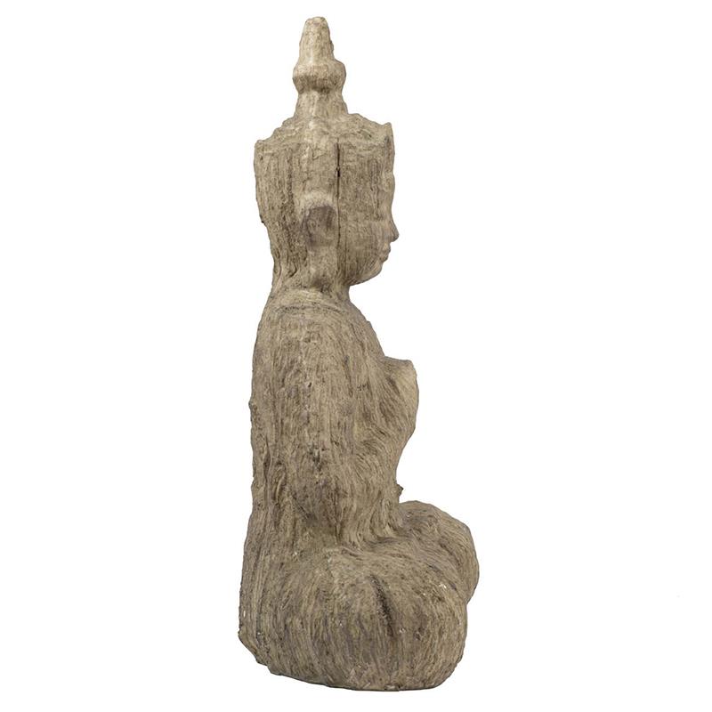 Stone Buddha statue in profile view.