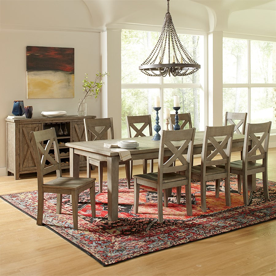 Elegant dining room with wooden table, rug, and chandelier.