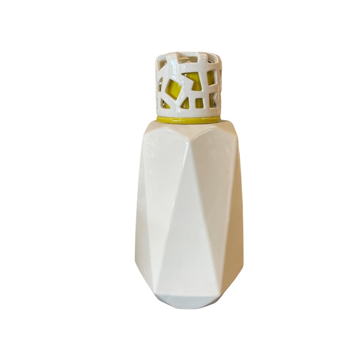 White ceramic vase with geometric design and cutout pattern on top.