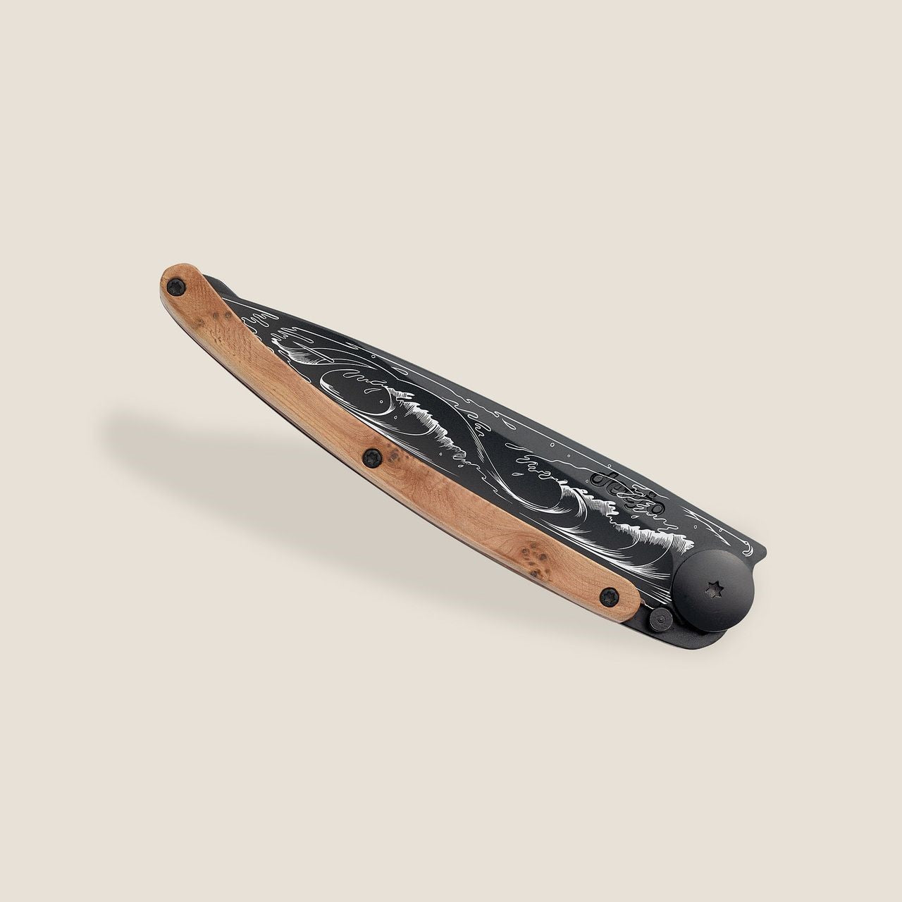 Artistic folding knife with engraved blade and wooden handle.