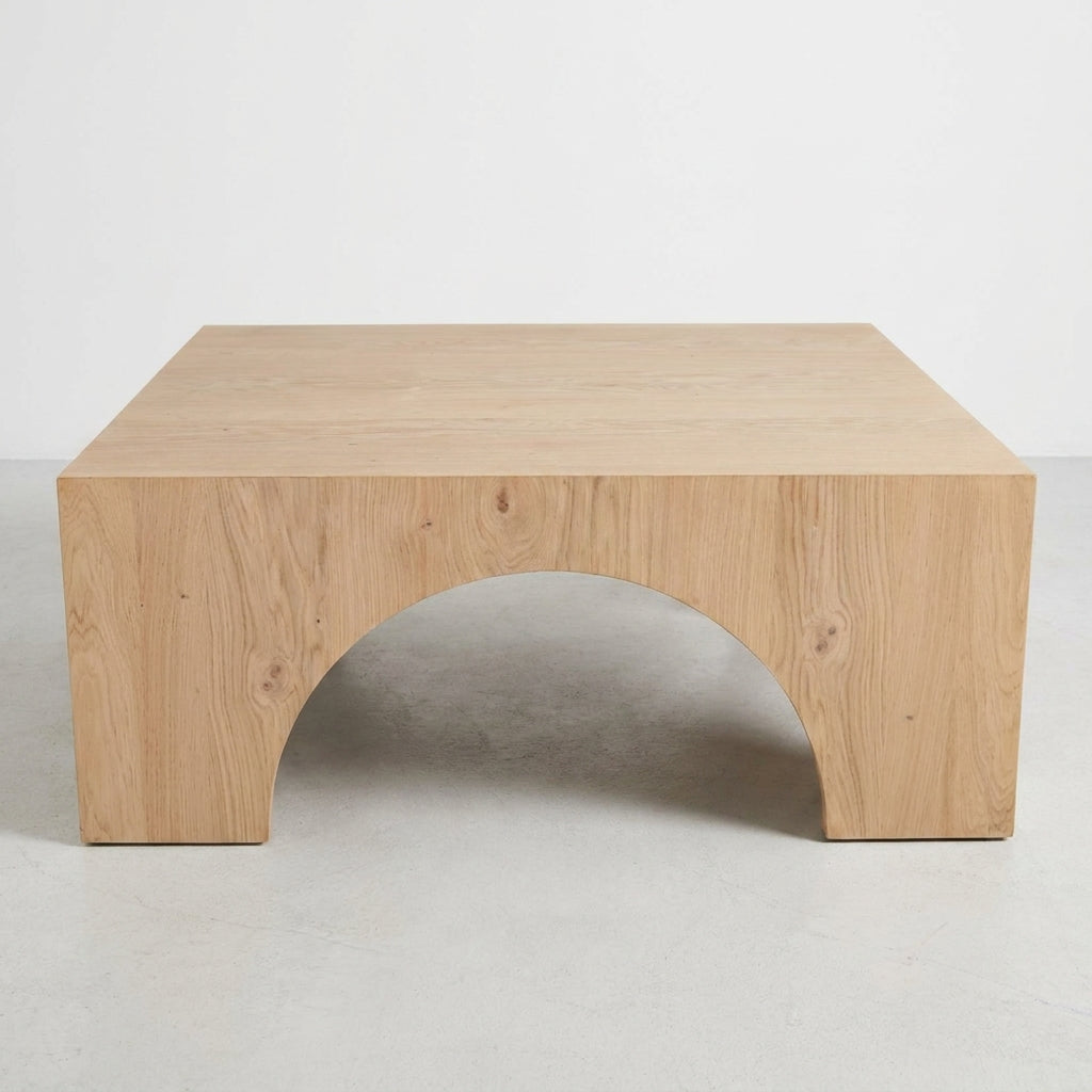 Wooden table with simple, modern design and arched cutout.