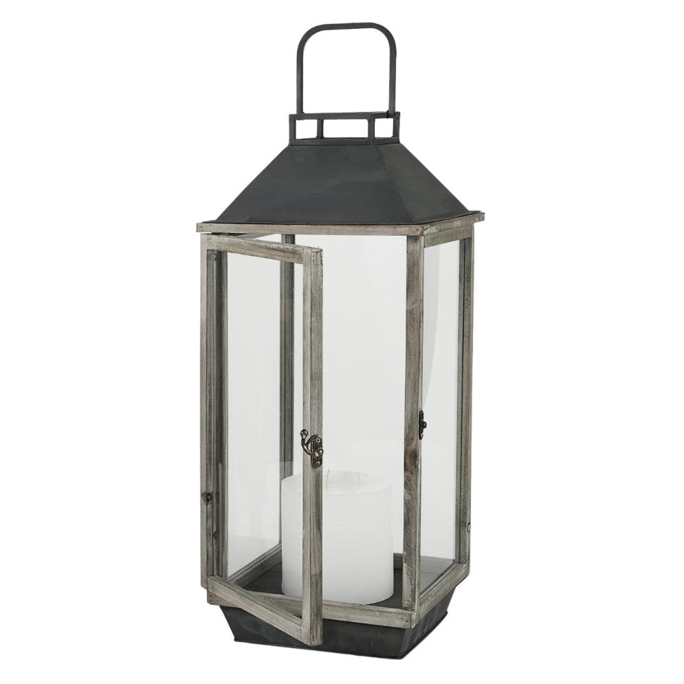 Rustic lantern with glass sides and a white candle inside.