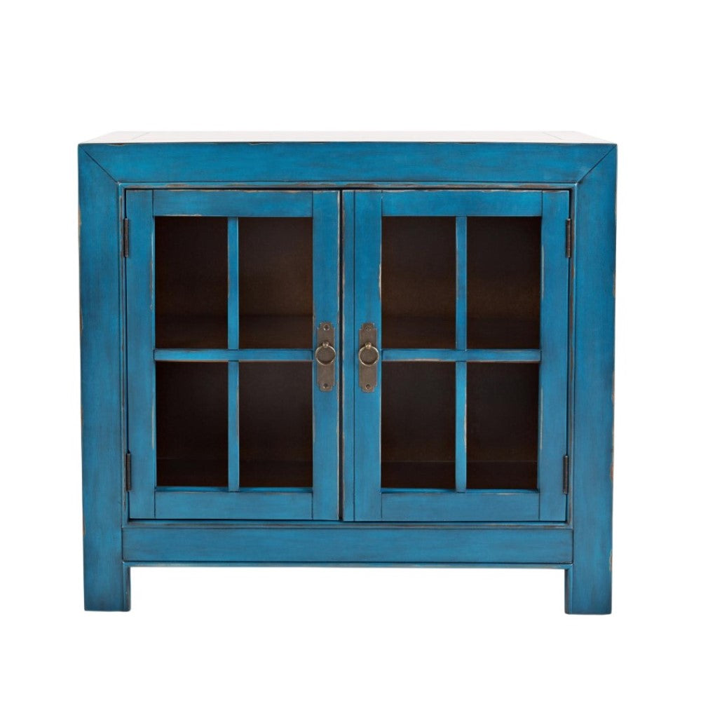 Blue cabinet with glass doors and metal handles.