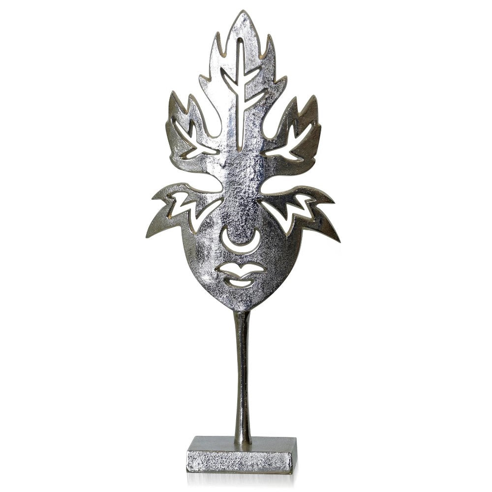 Silver leaf face mask sculpture on a pedestal.