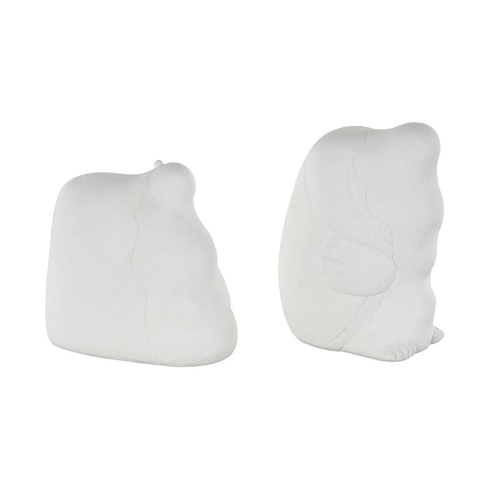 Two abstract, white stone sculptures side by side.