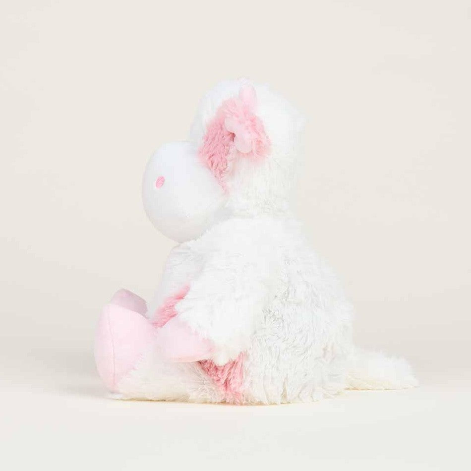 Fluffy pink and white unicorn plush toy, side view.