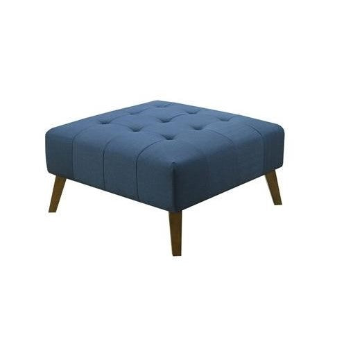 Blue tufted ottoman with wooden legs on a white background.