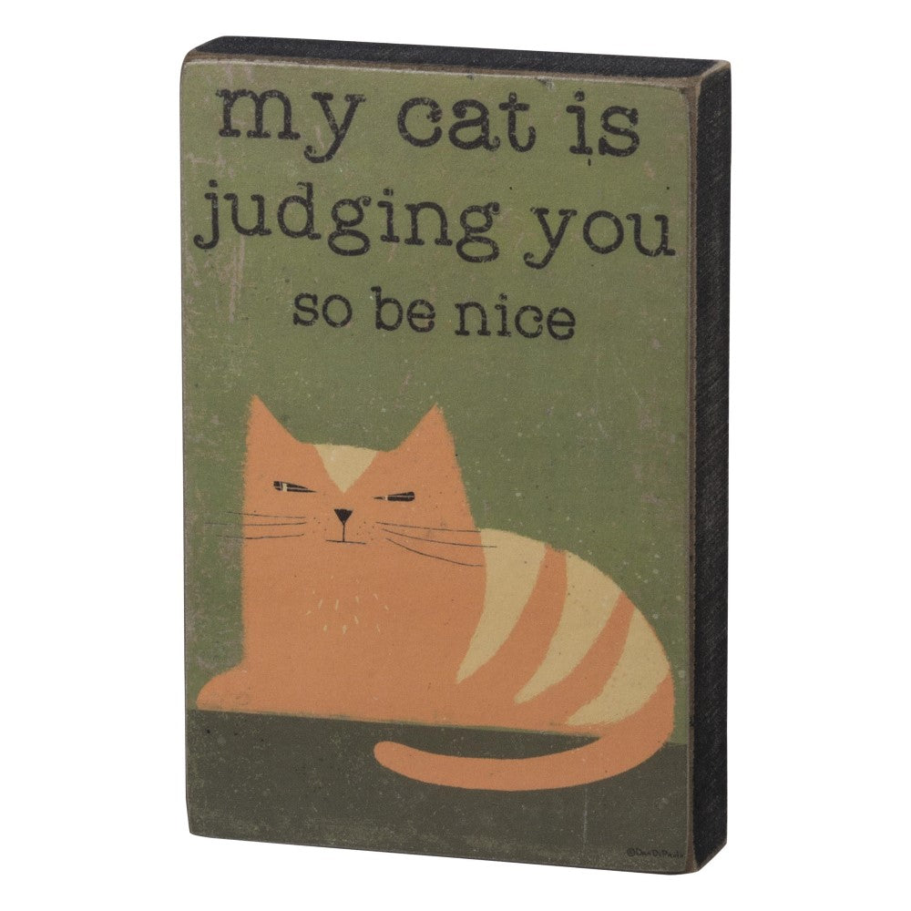 Cat illustration with text: "my cat is judging you so be nice".