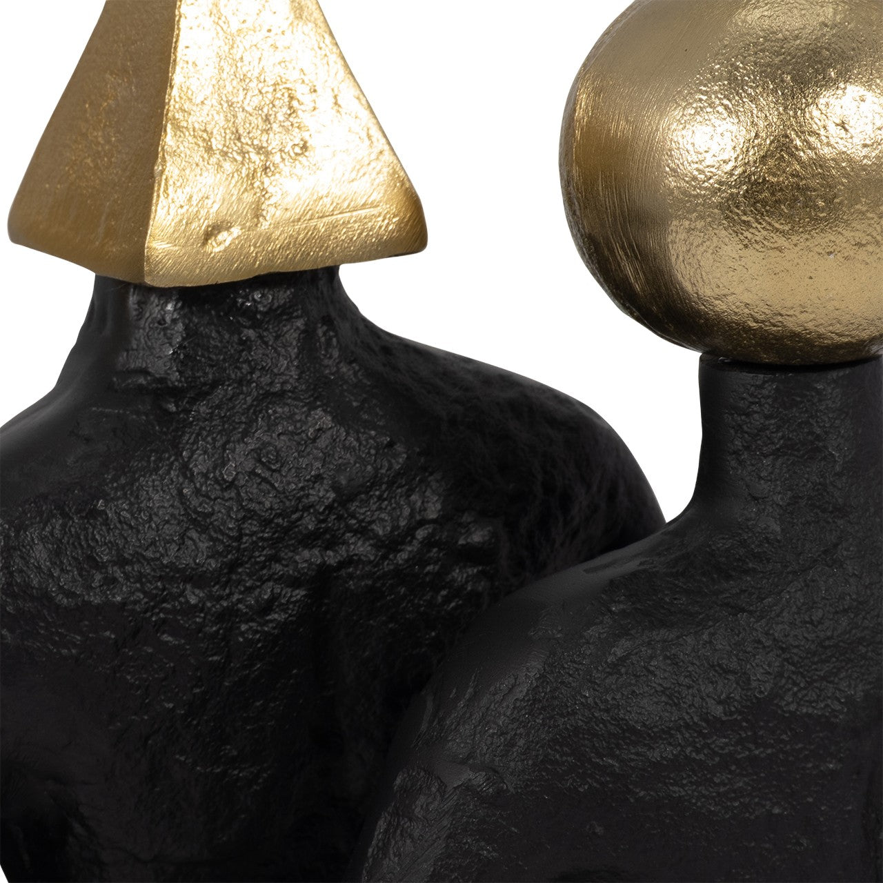 Two textured sculptures with gold geometric heads against a white backdrop.